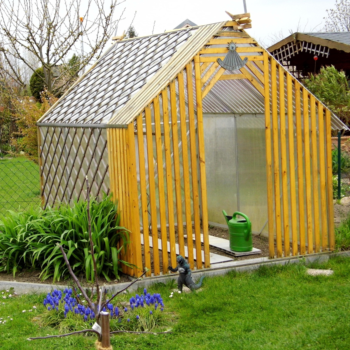 Carport transformed into a garden center with plants and potting station