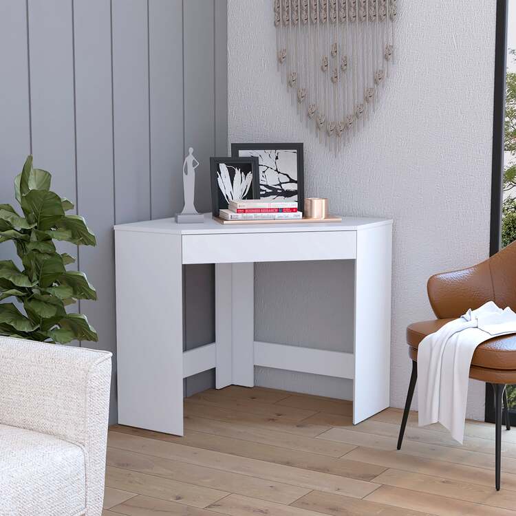 Compact writing desk positioned in corner of small bedroom